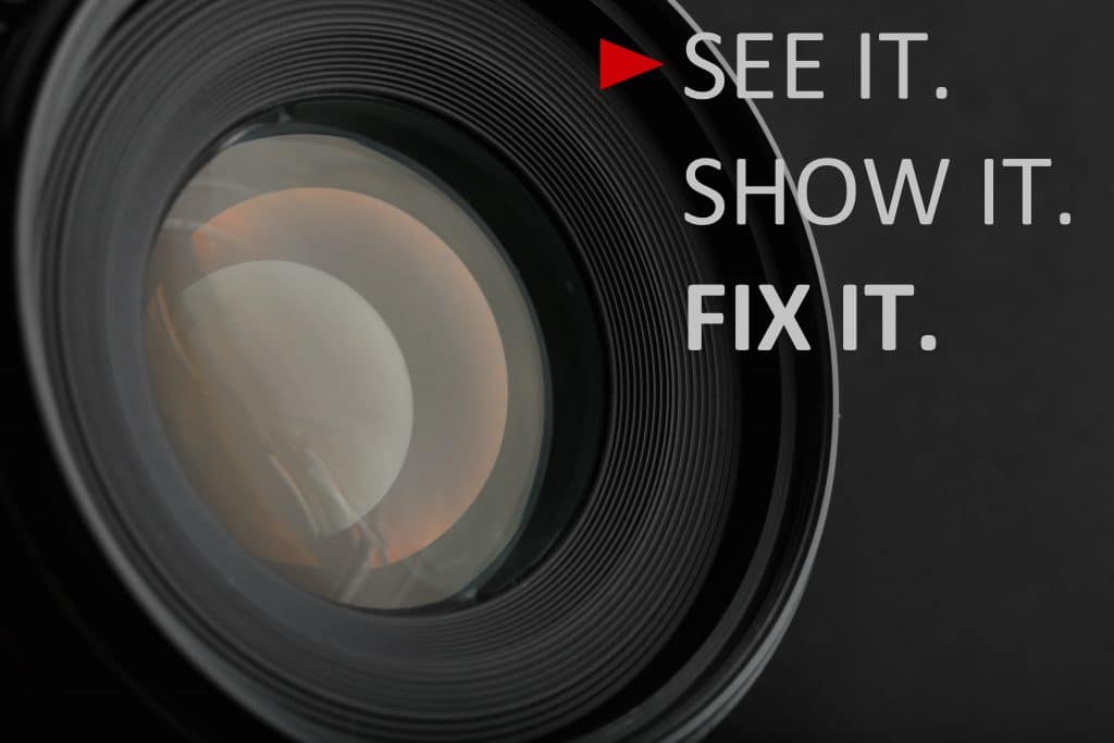 Close-up of a camera lens with a slogan and a play icon